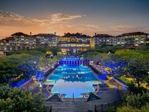 The Capital Hotel and Apartments illuminated at night with pool view, Sandton Johannesburg
